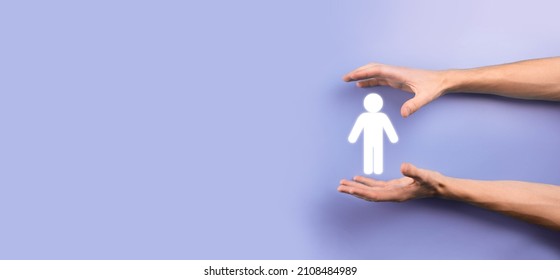 Male Hand Holding Human Icon On Blue Background. Human Resources HR Management Recruitment Employment Headhunting Concept.Select Team Leader Concept. Male Hand Click On Man Icon.Banner ,copy Spase