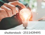 Male hand holding illuminated light bulb of new ideas with innovative technology and creativity. A light bulb looking for a new idea for a better working design. Conceptual ideas with innovation 