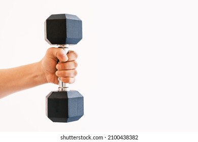 Male hand holding an iron dumbbell on white background, copy space.
