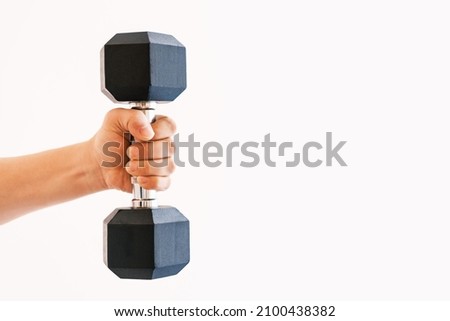 Male hand holding an iron dumbbell on white background, copy space.
