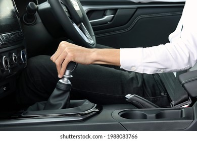 Male hand holding manual gearbox of car - Shutterstock ID 1988083766