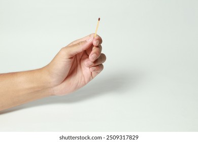 Male hand holding match sticks on isolated white background - Powered by Shutterstock