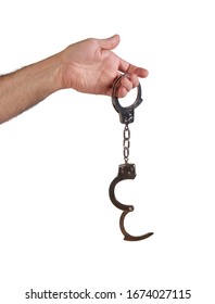 Male Hand Holding Metal Hand Cuffs Isolated On White Background .