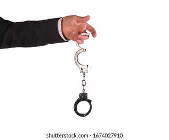 Male Hand Holding Metal Hand Cuffs Isolated On White Background .