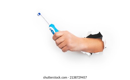 Male Hand Holding Modern Electric Toothbrush On White Background. Banner, Copy Space. Controlled Oral Hygiene Tool, Ad Space.