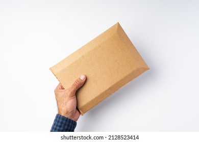 Male Hand Holding Parcel Post Against White Background, Close Up