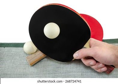 Male Hand Holding A Ping Pong Racket And A Table Tennis Ball Above A Net, Isolated On White