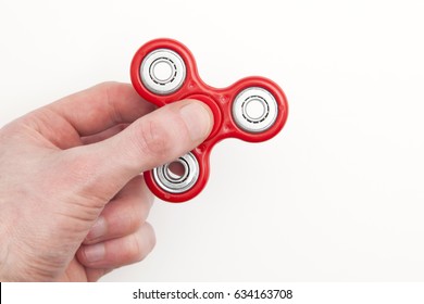 Male hand holding popular fidget spinner toy
