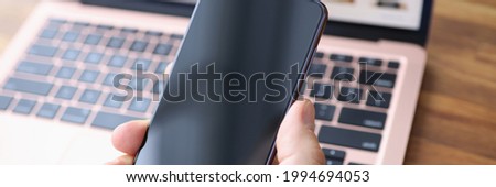 Male hand holding Samsung Galaxy S21 closeup