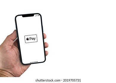 Male Hand Holding A Smartphone With Apple Pay App On Screen. White Background. Approximation Payment System. Rio De Janeiro, RJ, Brazil. July 2021.