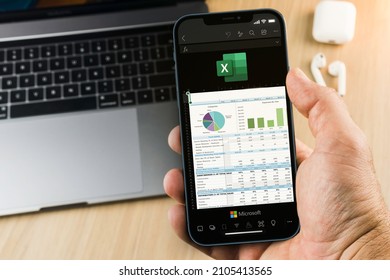 Male hand holding a smartphone with Microsoft Office Excel app on the screen. Office environment. Rio de Janeiro, RJ, Brazil. January 2022.