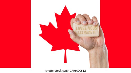 Male Hand Holding Soap With Words: Wash Your Hands Written In French Language With Canadian Flag Background