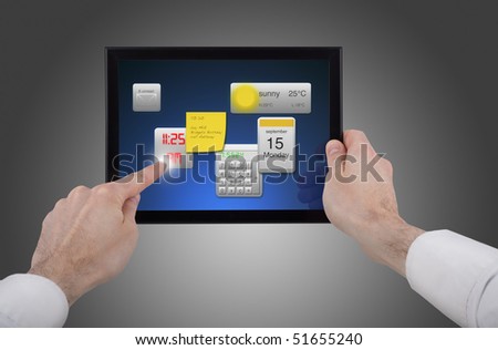a male hand holding a touchpad pc, one finger touches the screen and uses little programmes
