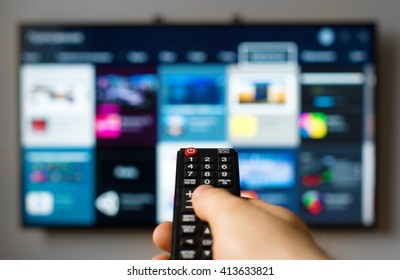 Male Hand Holding TV Remote Control.