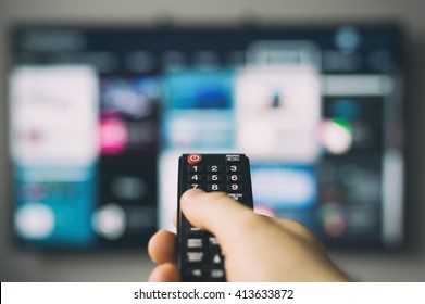 Male Hand Holding TV Remote Control.