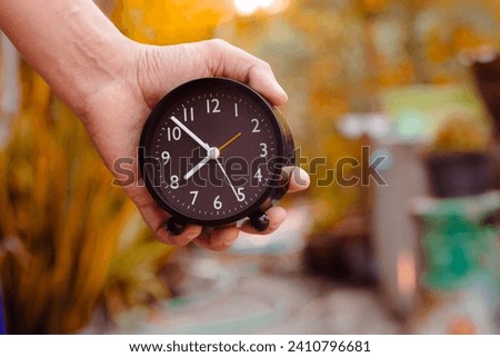 Male hand holding a watch It shows that life changes over time. and competition in daily life