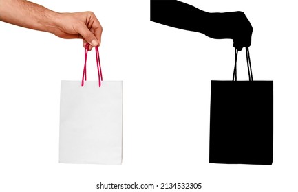 Male Hand Holding White Paper Bag With Red Handles Isolated On White Background. Gift Wrap Mockup With Black Silhouette As Clipping Path