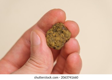 Male Hand Holds A Piece Of High Quality Hash. Medical Marijuana Extraction Hash Cannabis Pollen Hashish