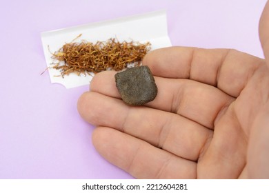 Male Hand Holds A Piece Of High Quality Hash. Medical Marijuana Extraction Hash Cannabis Pollen Hashish