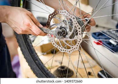 Male Hand Holds The Tool. The Process Of Repairing A Bike. Bicycle Wheel Breakage. Active Lifestyle. Self Repair Bike At Home. Image.