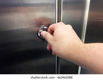 Male Hand Locking A Bathroom Stall Door