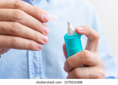 Male Hand With Medicine Nose Spray, Closeup