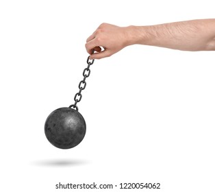 A male hand on a white background holding a black metal chain with a wrecking ball swinging on it. Heavy decisions. Holding heavy burden. Demolishing works.