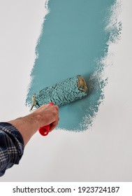 Male Hand Painting Wall With Paint Roller