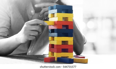 Male Hand Placed On A Tower Of Wooden Blocks On The Table Concept And Strategic Planning.
