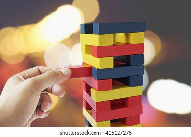 Male Hand Placed On A Wooden Block Tower, Background Bokeh. , Concept And Strategic Planning.