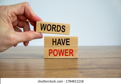 Male hand placing a block with word 'words' on top of a blocks tower with words 'have power'. Wooden table. Beautiful white background. Copy space. Business concept. - Shutterstock ID 1784811218