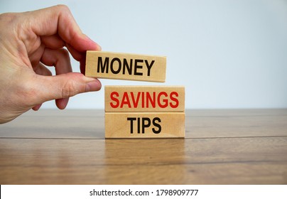 Male hand placing a block with word 'money' on top of a blocks with words 'money savings tips'. Beautiful wooden table, white background. Copy space. Business concept. - Shutterstock ID 1798909777