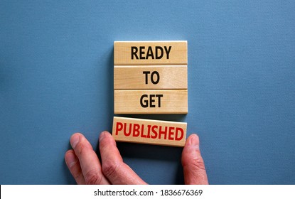 Male hand placing a block with word 'published' on a blocks tower with words 'ready to get published'. Beautiful blue background. Copy space. - Shutterstock ID 1836676369