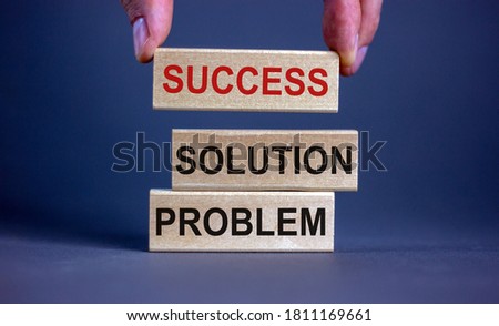 Male hand placing a block with word 'success' on top of a blocks tower with words 'problem, solution'. Beautiful grey background. Copy space. Business concept.