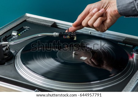Male Hand Placing Stylus on Vinyl Record