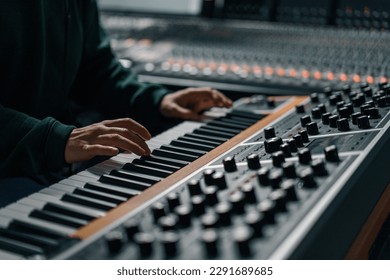 Male hand play electronic piano keyboard Fingers tap keys midi controller Musician produces song in recording studio - Powered by Shutterstock