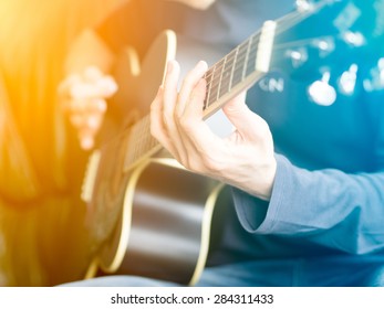 Male hand playing on acoustic guitar. Close-up.  - Powered by Shutterstock