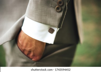 Male Hand In Pocket. Man In Grey Business Suit And White Shirt With Square Cufflinks. Outdoor Background.