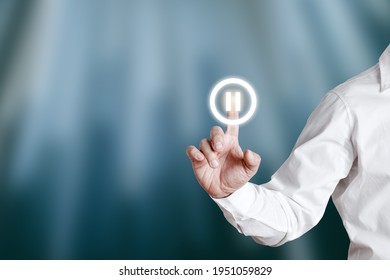 Male hand pressing pause icon on a virtual display screen. - Shutterstock ID 1951059829