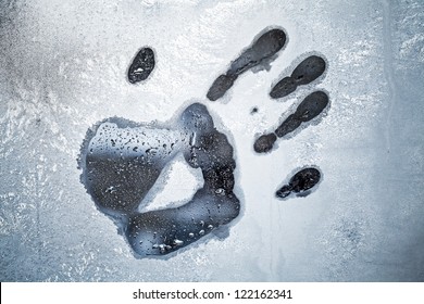 Male Hand Print On Frozen Windows Glass