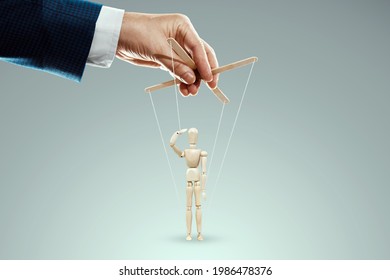 Male hand, puppeteer controls puppet, doll salutes, soldier. The concept of the army, orders, manipulation, control army - Shutterstock ID 1986478376