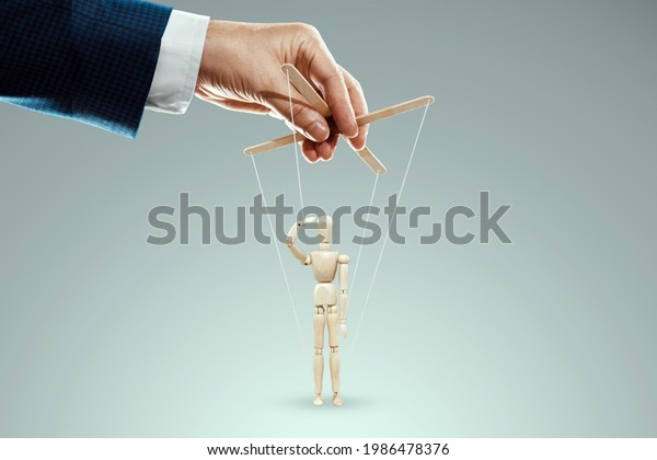 Male\
hand, puppeteer controls puppet, doll salutes, soldier. The concept\
of the army, orders, manipulation, control\
army