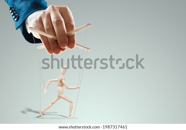 Male hand, puppeteer controls the\
puppet puppet with strings. A doll on her knees. The concept of\
world conspiracy, world government, manipulation,\
control