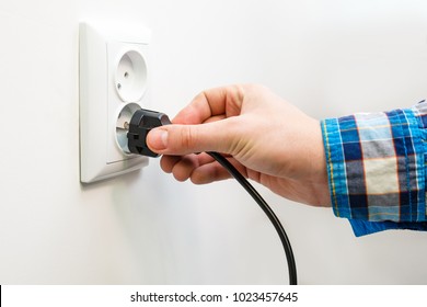 Male Hand Puts Plug In The Socket