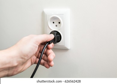 Male Hand Puts Plug In The Socket