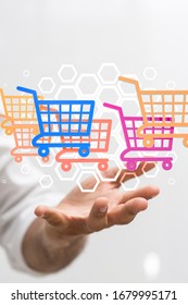 A male hand and shopping carts-concept of online shopping
