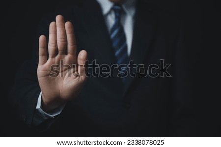 male hand showing stop gesture Concept of stop violence. Warning, prohibition, denial. On dark background. [[stock_photo]] © 