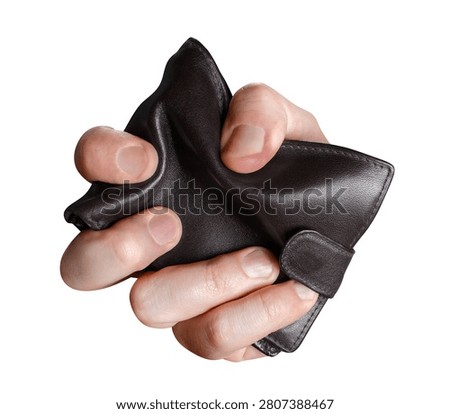 Male hand squeezing empty black leather wallet, isolated on white background