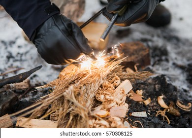 Male Hand Starts Fire With Magnesium Fire Steel, Fire Striker. Survival Concept