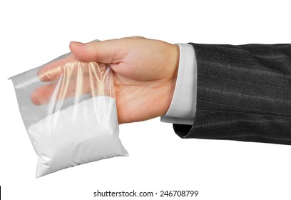 Male hand in suit with package of drugs isolated on white background